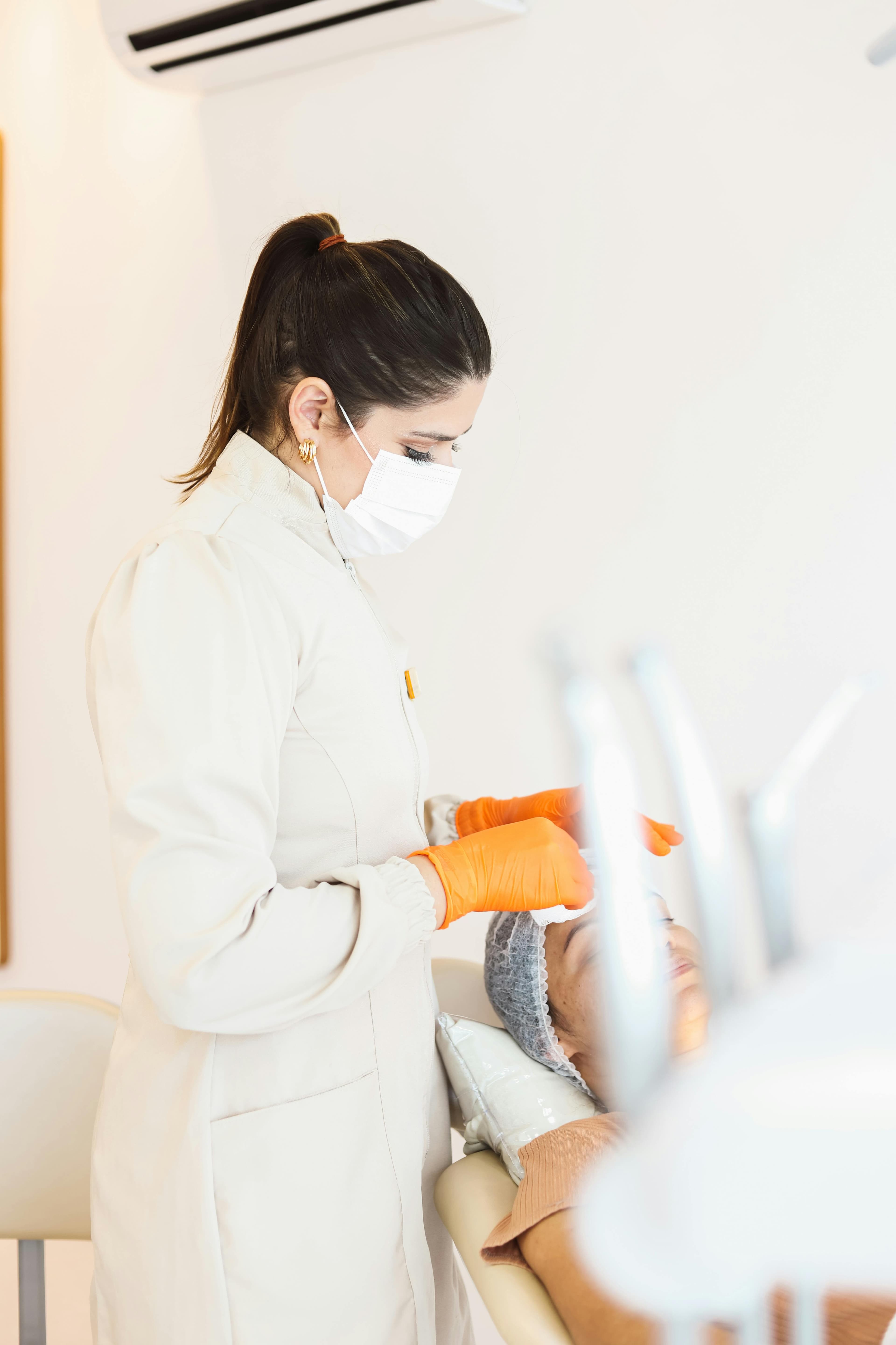 Dentist performing a gum examination and treatment on a patient